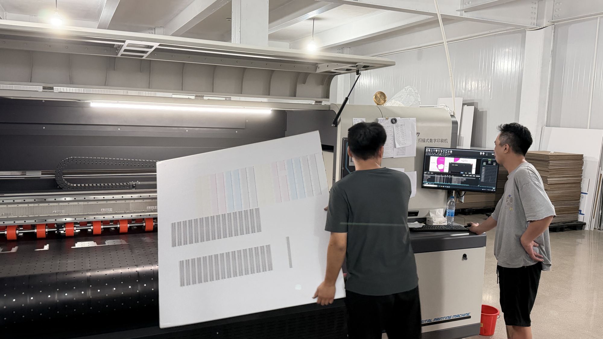 TYCHEN technicians calibrating a scanning digital printer with a color test chart