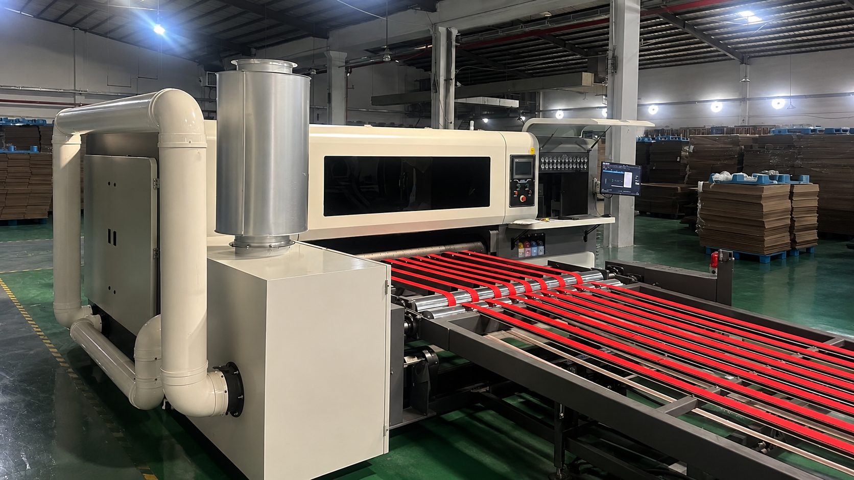 Corrugated boards moving through a TYCHEN digital printing production line